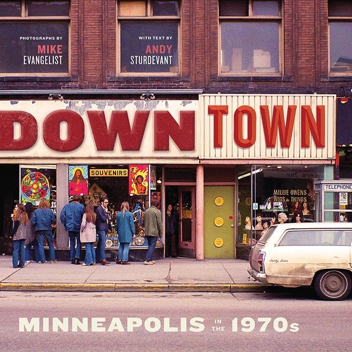 Product Description: Photographs by Mike Evangelist with text by Andy Sturdevant.</br></br>Downtown Minneapolis in the early 1970s was a scene.</br>Dayton's was in its prime, the new Nicollet Mall was full of people, the Foshay Tower was still king, and the IDS Center was beginning its rise. Bustling sidewalks teemed with shoppers and businessmen, young and old, no matter what the weather, because the skyway system was just being born.</br></br>Mike Evangelist, a seventeen-year-old from the suburbs, found everything about the city to be amazing. He turned his lens to the scenes around him--young women hitching a ride, a disabled vet selling pencils, stylish shoppers strolling Nicollet Mall, once-grand movie houses on Hennepin Avenue--capturing a vibrant and rapidly changing city.</br>Writer and artist Andy Sturdevant, who has been called "the preeminent wit, flâneur, and psycho-historian of the Twin Cities," explores these streets as a congenial companion, commenting with a sharp eye and thoughtful insights.</br></br>Do you miss the seventies? Did you miss the seventies?Downtowntakes you there.</br> Downtown Minneapolis in the 1970s