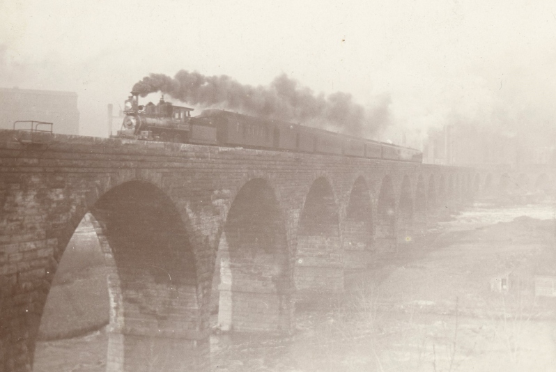 Product Description: Matted print of photograph, "Stone Arch Railway Bridge with Train Crossing", c. 1880.</br> Matted Print: Stone Arch Railway Bridge with Train